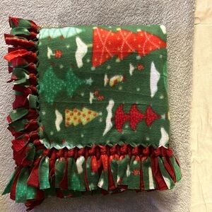 50x60” fleece tie blanket. Christmas pattern fleece with red fleece backing